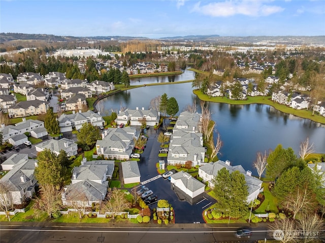 drone / aerial view featuring a residential view and a water view