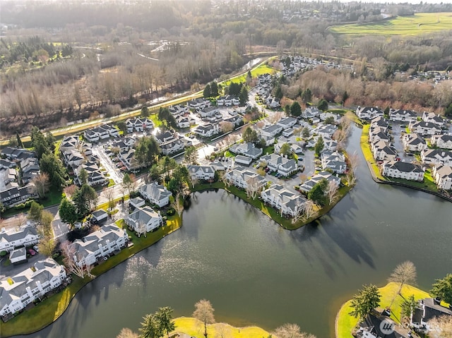 birds eye view of property with a water view and a residential view