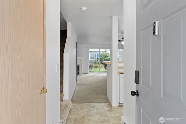 interior space with light carpet and a ceiling fan