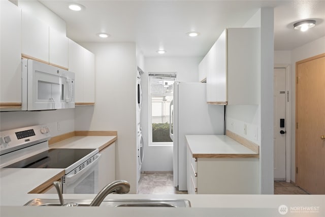 kitchen with recessed lighting, white appliances, a sink, white cabinets, and light countertops