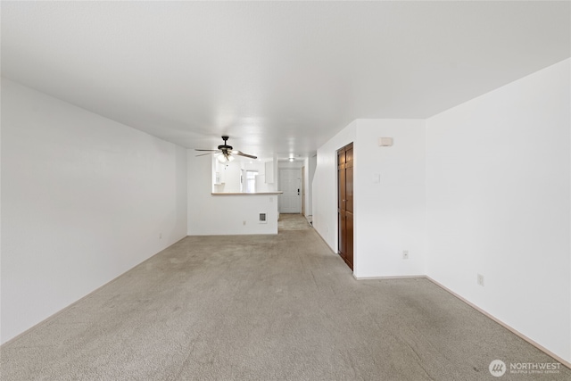 unfurnished living room with light carpet and ceiling fan