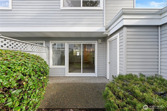 property entrance with a patio and a balcony