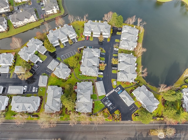 birds eye view of property featuring a water view and a residential view