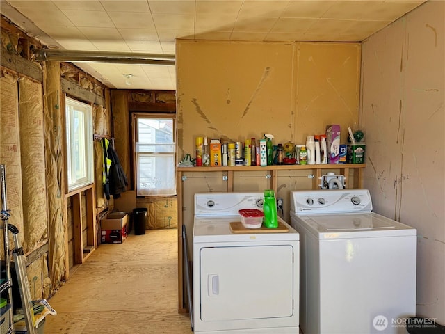 laundry area featuring laundry area, washer and clothes dryer, and wood finished floors