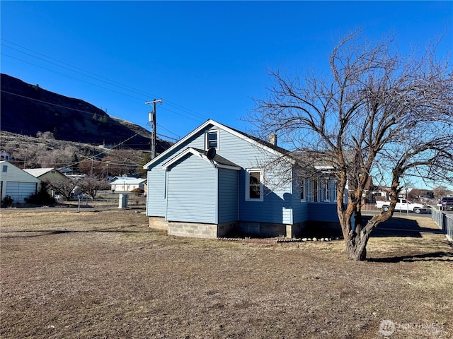 view of property exterior with fence