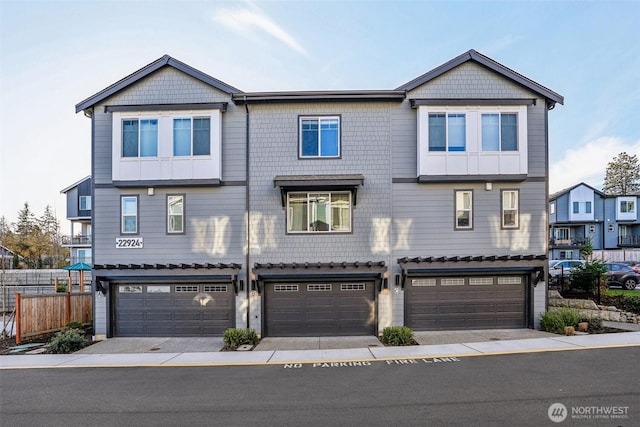 multi unit property featuring a garage and fence