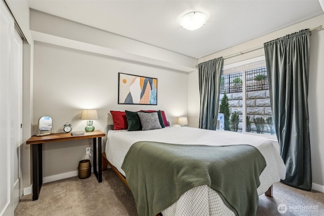 bedroom featuring carpet flooring and baseboards