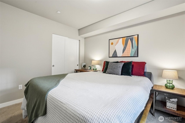 bedroom featuring carpet flooring and baseboards