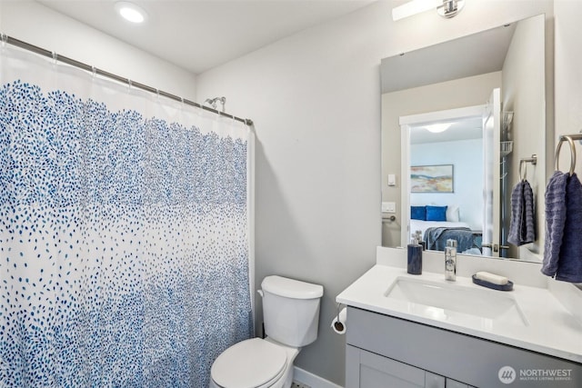 ensuite bathroom with toilet, a shower with curtain, connected bathroom, and vanity