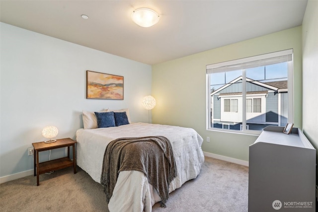 carpeted bedroom featuring baseboards