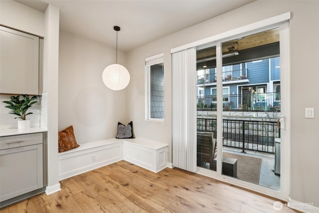 interior space featuring light wood-type flooring and a decorative wall