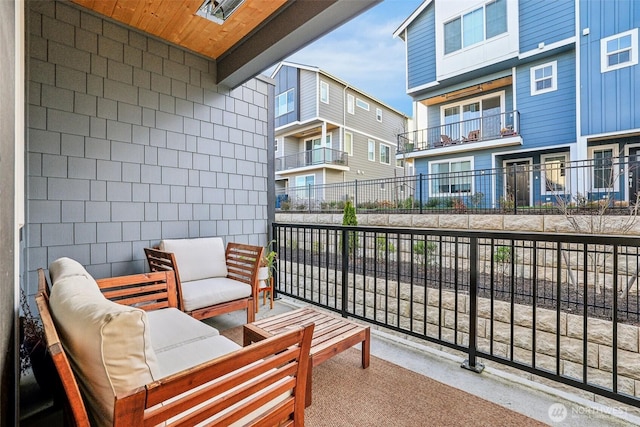 balcony with a residential view and an outdoor living space