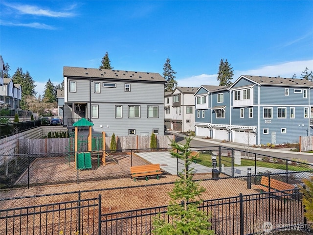 view of playground with fence and a residential view