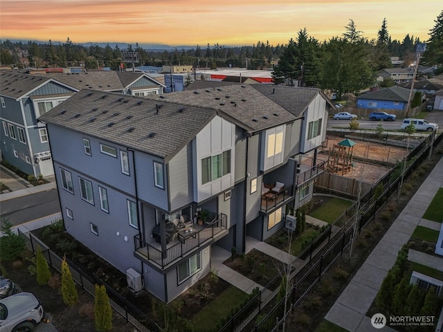 aerial view at dusk featuring a residential view