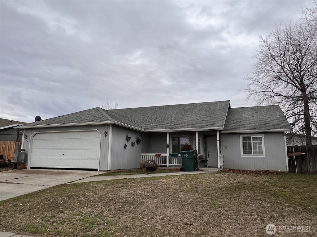 ranch-style house with driveway, an attached garage, covered porch, fence, and a front yard