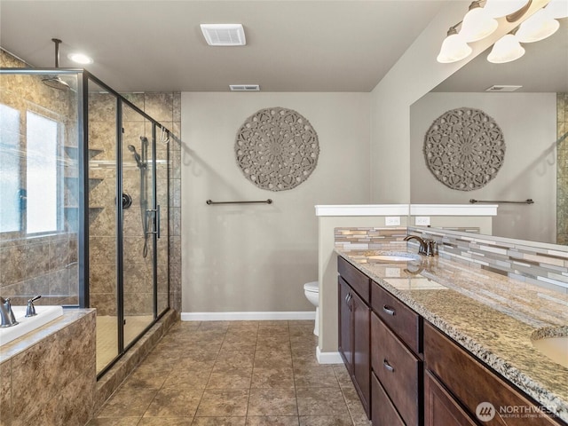 full bath featuring tasteful backsplash, a stall shower, a sink, and visible vents