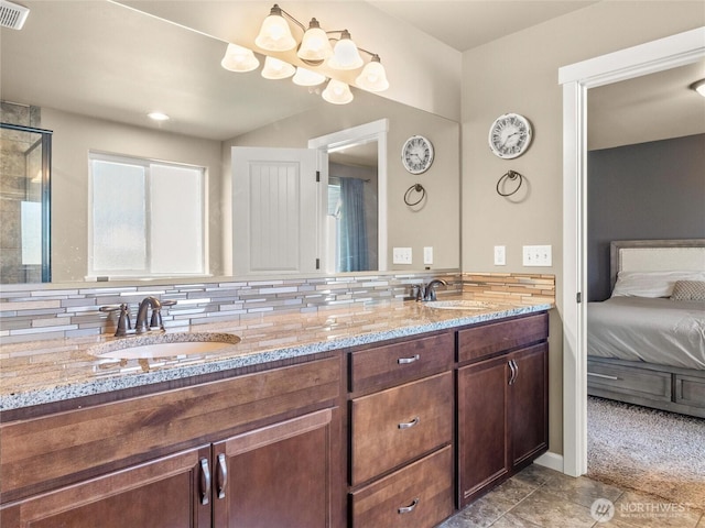 bathroom featuring double vanity, ensuite bath, a sink, and visible vents