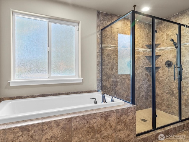 full bathroom featuring a stall shower and a garden tub