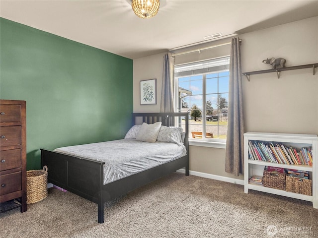 carpeted bedroom with visible vents and baseboards