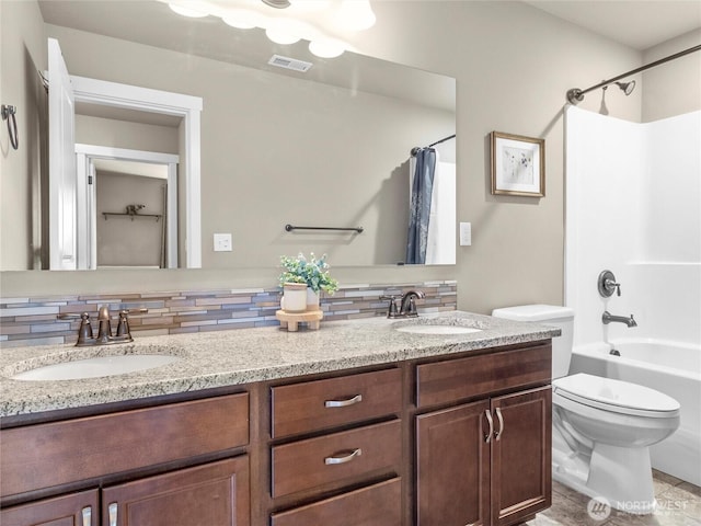 bathroom with visible vents, a sink, backsplash, and toilet