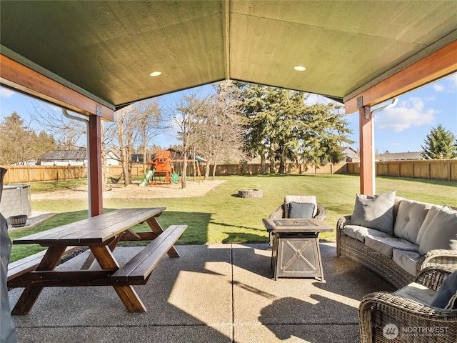 view of patio with a playground, a fenced backyard, and an outdoor living space