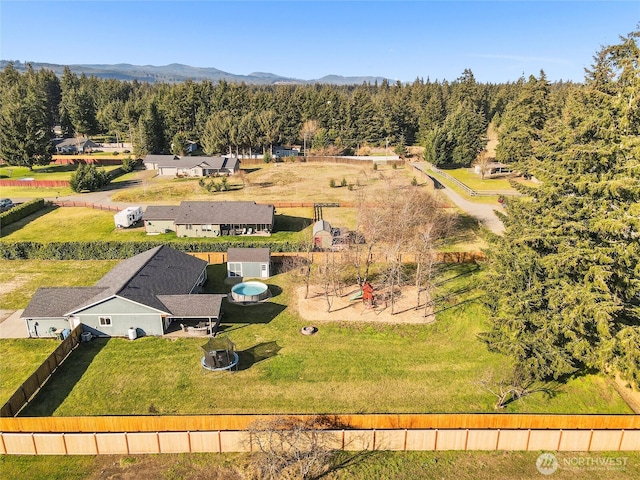 drone / aerial view with a mountain view and a view of trees