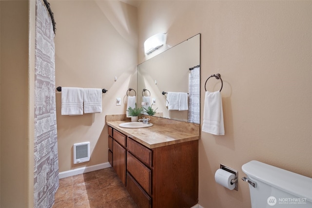 bathroom with toilet, baseboards, visible vents, and vanity