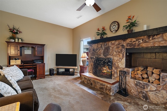 living room with visible vents, light colored carpet, a ceiling fan, a stone fireplace, and baseboards