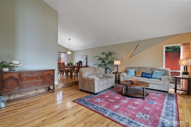 living area with lofted ceiling and wood finished floors