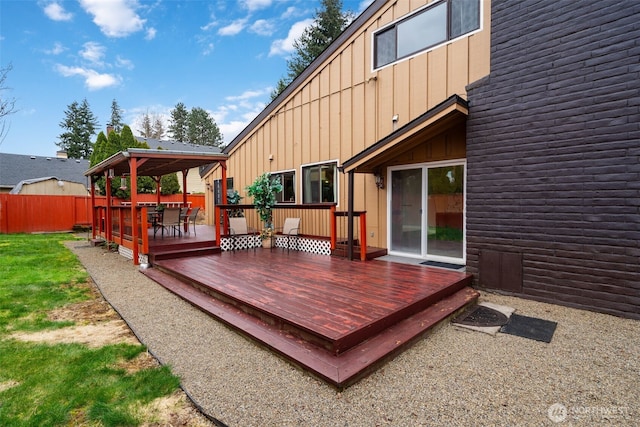 wooden terrace with fence and a yard