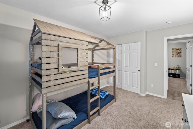 carpeted bedroom featuring baseboards