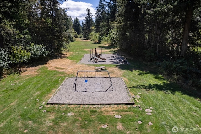 view of property's community with a playground and a yard