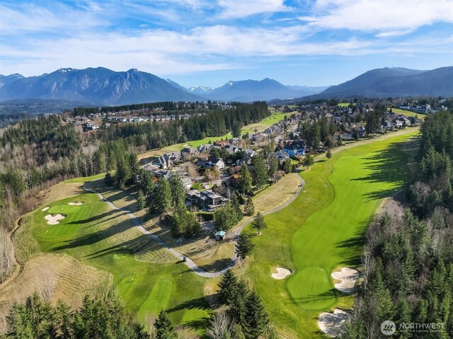 birds eye view of property with view of golf course and a mountain view