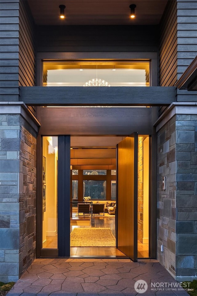 entrance to property featuring stone siding