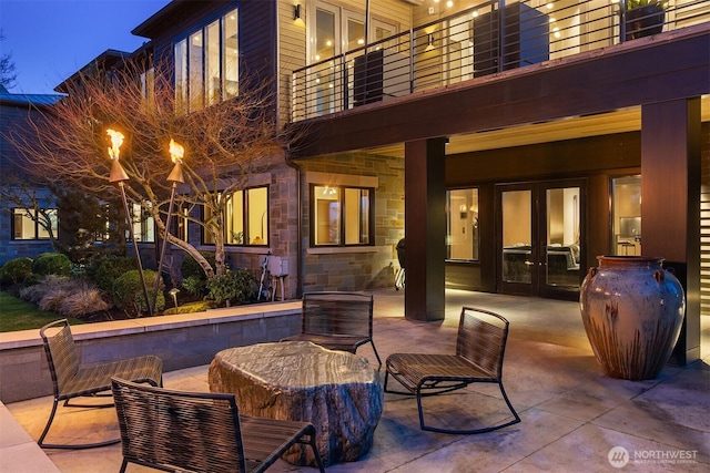 view of patio / terrace with french doors and a balcony