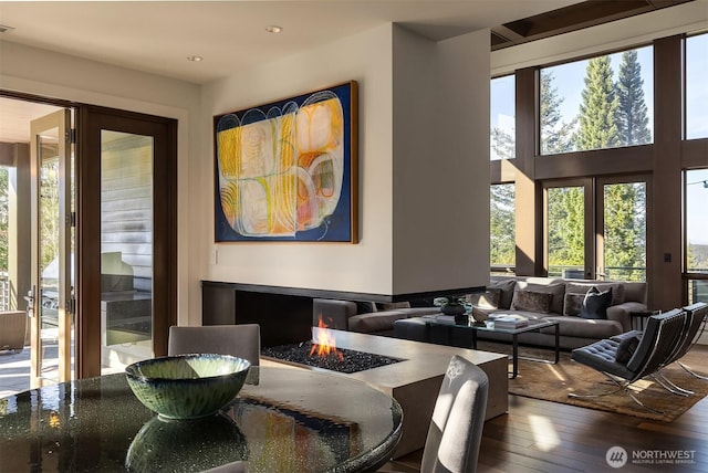 interior space with recessed lighting, french doors, a high ceiling, and hardwood / wood-style floors