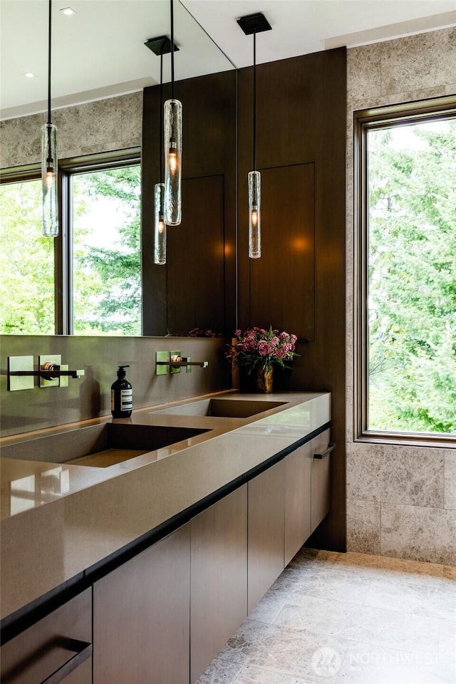 kitchen with hanging light fixtures and a healthy amount of sunlight