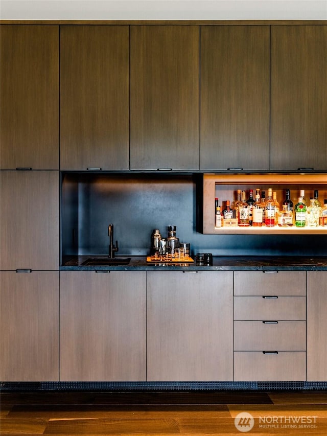 bar featuring wet bar and a sink