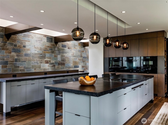 kitchen featuring dark countertops, modern cabinets, dark wood-style floors, and white cabinets