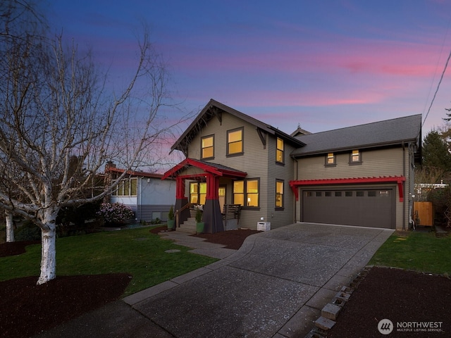 traditional-style home featuring concrete driveway and a yard