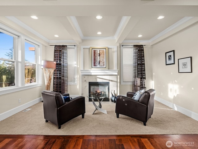 living room with baseboards, wood finished floors, and crown molding