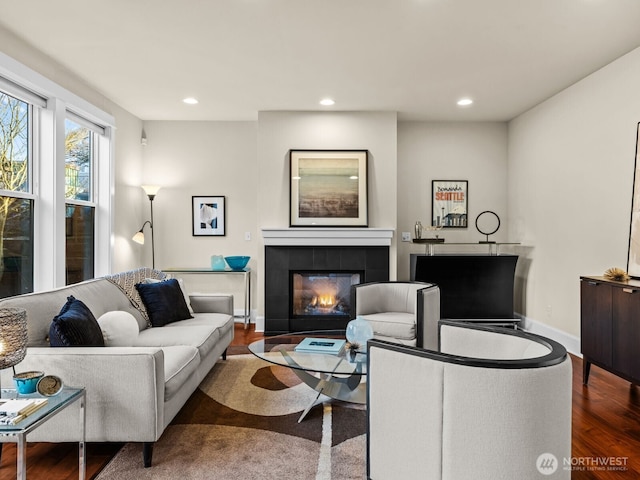 living area with baseboards, a fireplace, wood finished floors, and recessed lighting