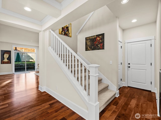 stairs with baseboards, wood finished floors, and recessed lighting