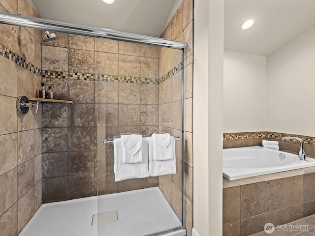 full bath featuring a shower stall, a bath, and recessed lighting