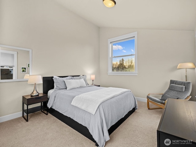 bedroom with carpet, baseboards, and vaulted ceiling