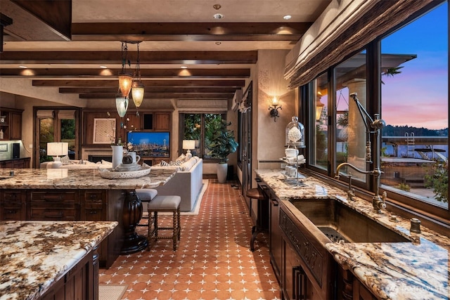 bar with beam ceiling, decorative light fixtures, and a sink