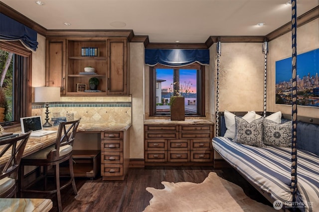 interior space with ornamental molding, dark wood-style flooring, built in study area, and backsplash