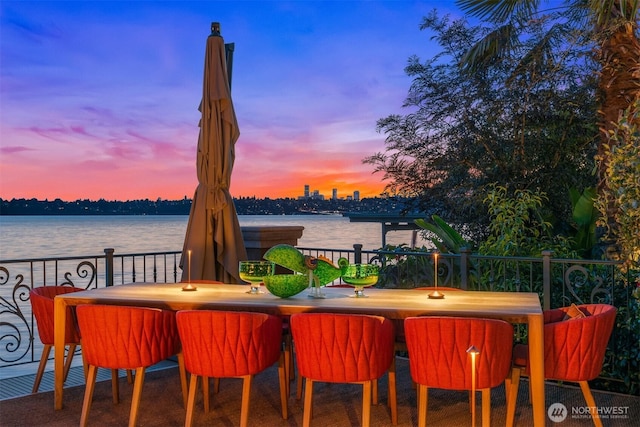 view of patio / terrace with a water view and outdoor dining area