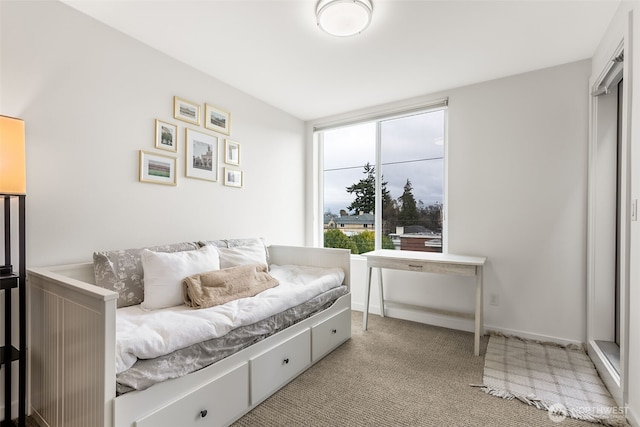 bedroom with light carpet and baseboards