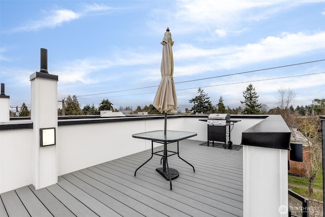 wooden terrace with a grill